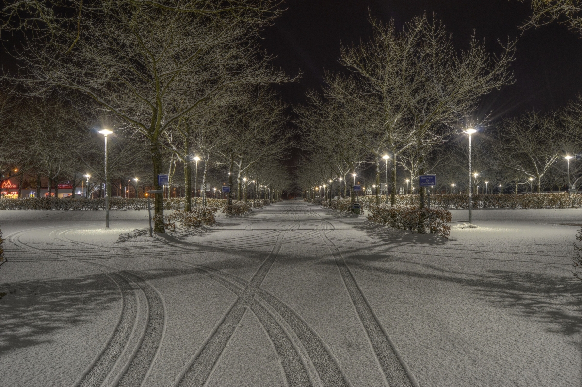 A snowy road at night